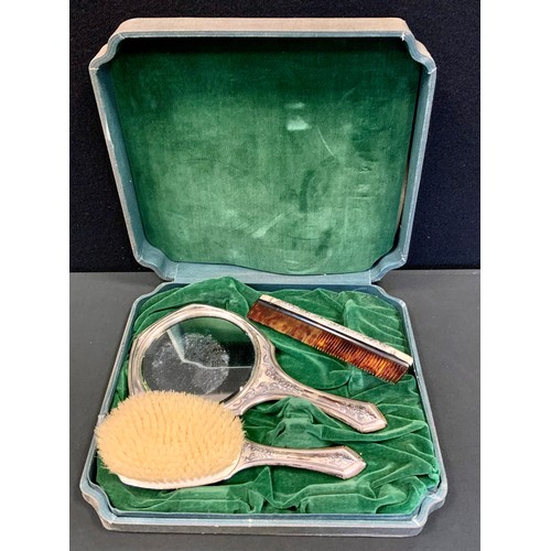 378 - A continental silver three piece dressing table set, hand mirror, comb and brush, stamped sterling, ... 