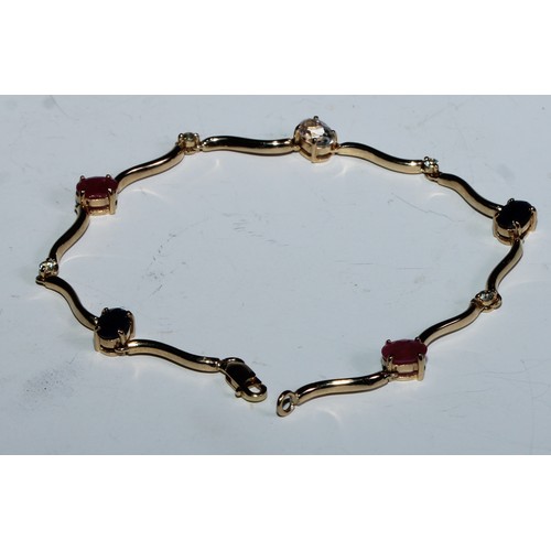 415 - A fancy link ruby, sapphire, diamond and white stone bracelet, shaped wave bar links divided by alte... 