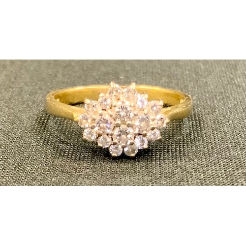 427 - A diamond cluster ring, shaped cluster of eighteen round brilliant cut diamonds, total estimated dia... 