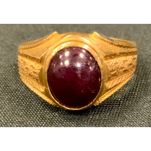 431 - A yellow metal and red cabochon signet ring, stamped 22K, size U, 6.2g gross