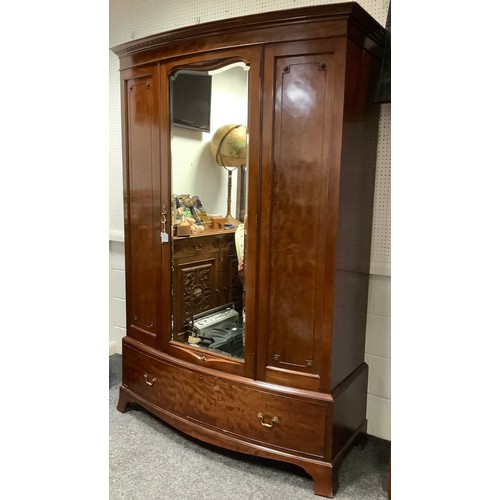 327 - An early 20th century mahogany bow-front wardrobe, moulded cornice, single central mirrored door wit... 