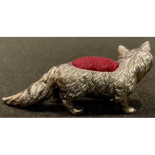 223 - A silver novelty pin cushion, as a fox, ruby eyes, 6cm long