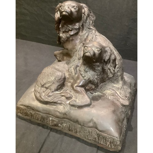 265 - After Charles Valton, a brown-patinated animalier bronze, of King Charles Spaniels, seated upon a cu... 