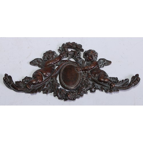 197 - A 19th century brown patinated bronze applique, cast as putti crowning a cartouche with laurel, 15cm... 