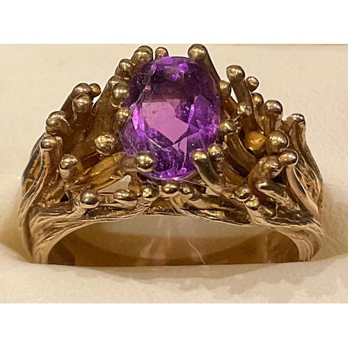 431 - A 9ct gold modernist ring, set with a single oval cut amethyst, surrounded by fronds of gold, size P... 