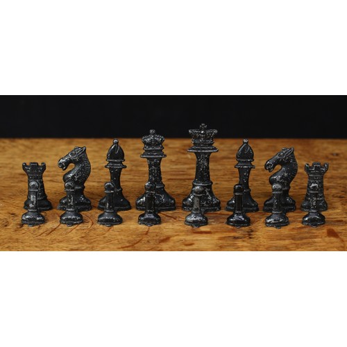 466 - An early 20th century painted lead chess set, most pieces stamped ‘MADE IN ENGLAND’ to the bases, th... 