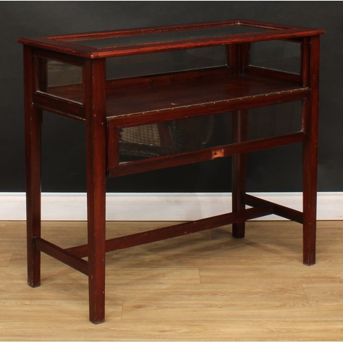 115 - A mahogany bijouterie table, glazed top and sides, fall front, 90cm high, 102.5cm wide, 47.5cm deep