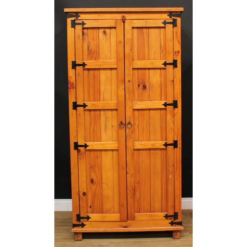 120 - A pine three-piece bedroom suite, comprising wardrobe, 190cm high, 94cm wide, 62cm deep, hanging pre... 