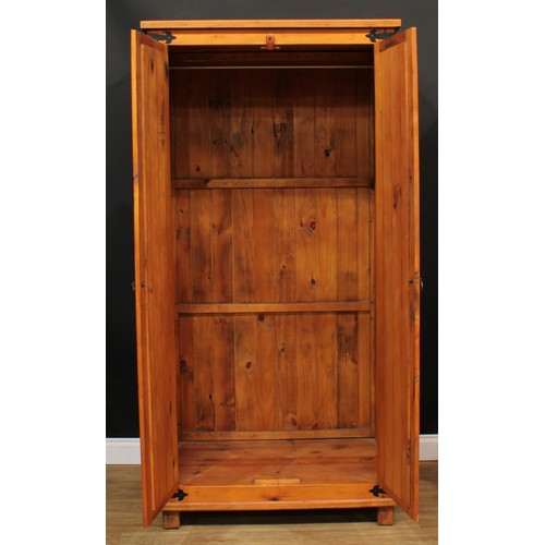 120 - A pine three-piece bedroom suite, comprising wardrobe, 190cm high, 94cm wide, 62cm deep, hanging pre... 