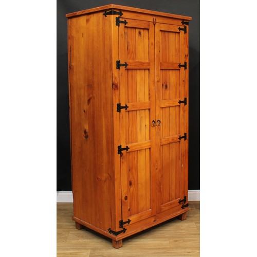 120 - A pine three-piece bedroom suite, comprising wardrobe, 190cm high, 94cm wide, 62cm deep, hanging pre... 