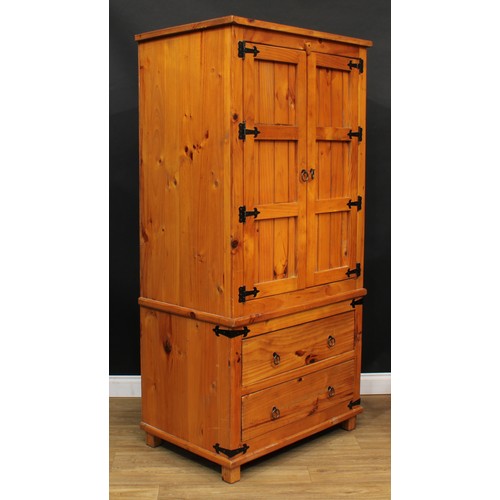 120 - A pine three-piece bedroom suite, comprising wardrobe, 190cm high, 94cm wide, 62cm deep, hanging pre... 