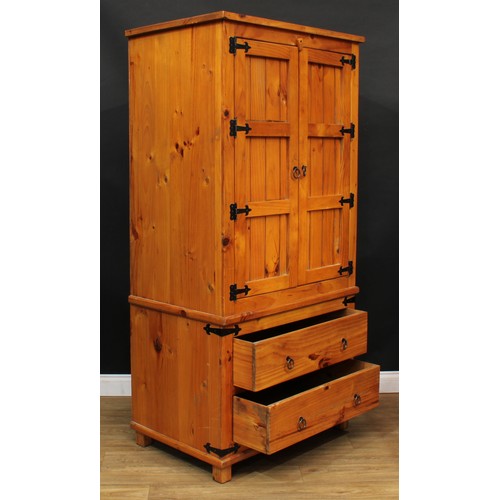 120 - A pine three-piece bedroom suite, comprising wardrobe, 190cm high, 94cm wide, 62cm deep, hanging pre... 