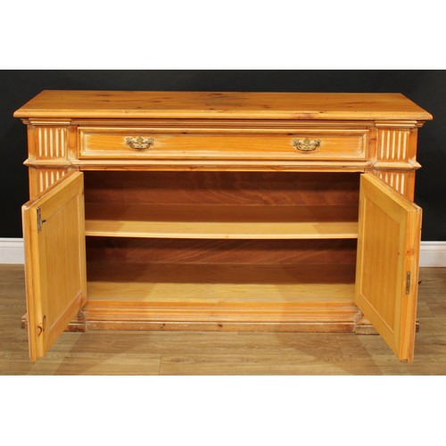 202 - A 19th century style pine low dresser or side cabinet, moulded oversailing top above a long frieze d... 