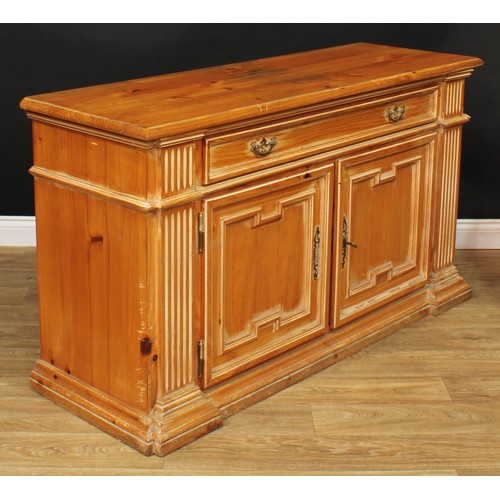 202 - A 19th century style pine low dresser or side cabinet, moulded oversailing top above a long frieze d... 