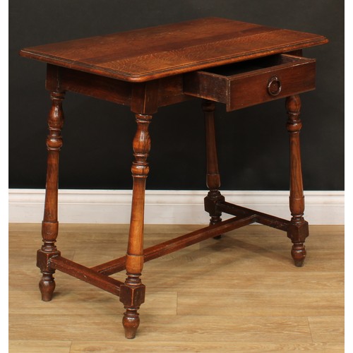 211 - A Spanish Baroque style oak side table, rounded rectangular top with moulded edge above a single fri... 