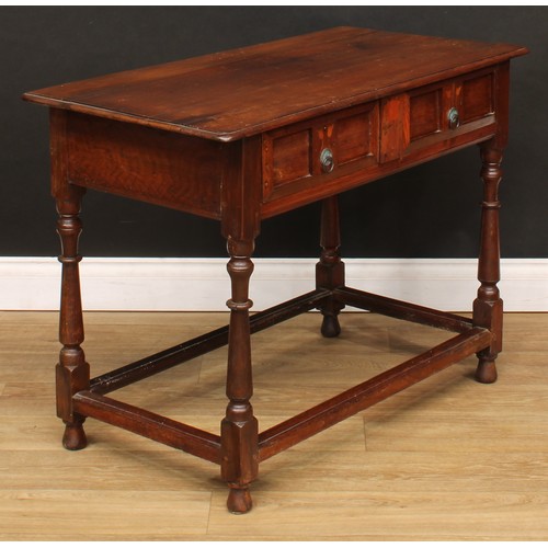 213 - An oak side table, slightly oversailing top above a long frieze drawer, the front inlaid in the Art ... 