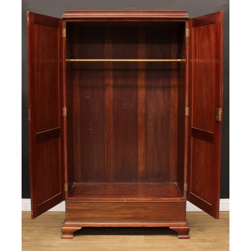 220 - A George III Revival mahogany wardrobe, moulded cornice above a pair of doors set with raised and fi... 