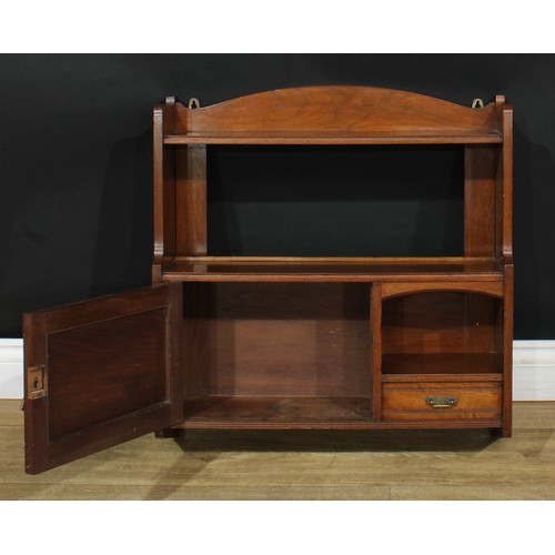 119 - A Victorian Aesthetic Movement walnut salon wall cabinet, arched cresting above an open shelf, a por... 