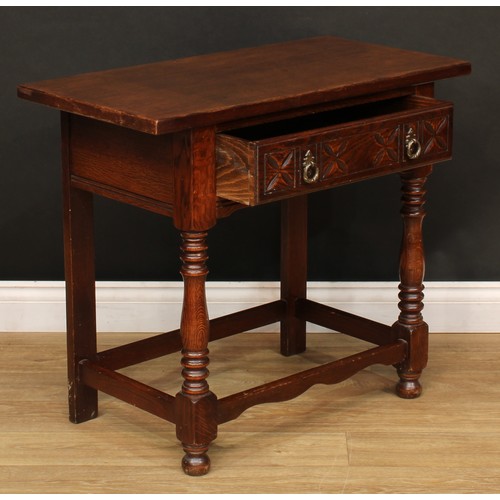 525 - A 17th century style oak side table, oversailing top above a carved frieze drawer, turned supports, ... 