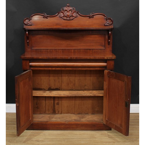 114 - A Victorian mahogany chiffonier, shaped back with serpentine shelf carved and applied with C-scrolls... 