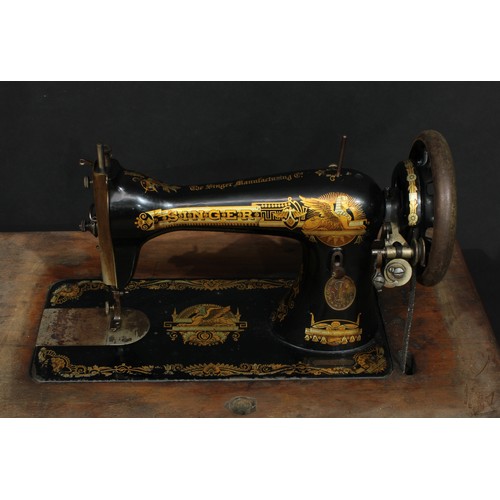 542 - An early 20th century Egyptian Revival Singer sewing machine, 'The Memphis Sphinx', treadle base; an... 