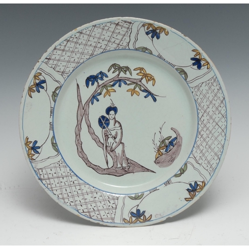 377 - A mid-18th century Bristol Delft circular plate, painted in the Chinoiserie taste in tones of underg... 