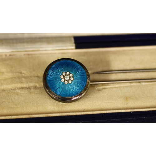 319 - A pair of silver blue guilloche enamel hat pins, the circular pivoting terminals as styalised flower... 