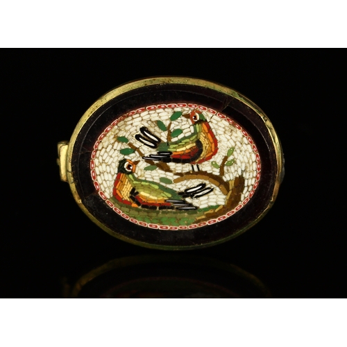 302 - A 19th century oval grand tour micromosaic brooch, decorated with styalised birds resting and perche... 