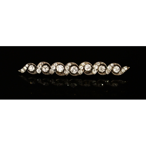 313 - A good diamond bar brooch, the seven old brilliant cut stones set in a line and divided by a Vitruvi... 