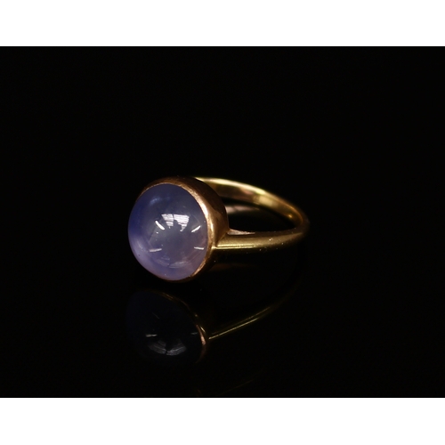 306 - A cabochon star sapphire and gold coloured metal ring, size M/N, 5.9g gross.