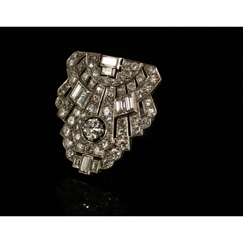 334 - An Art Deco diamond dress clip, closely set with a stylish arrangement of baguette and brilliant sto... 