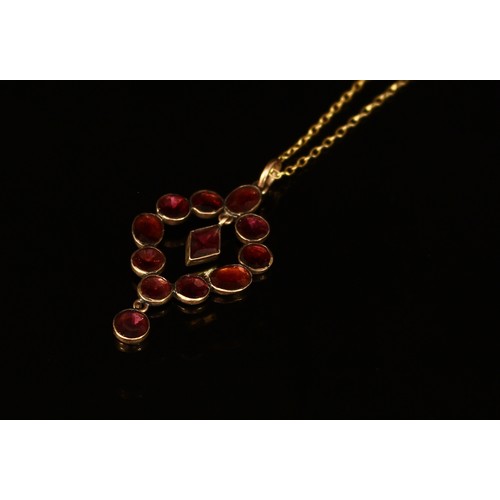 338 - An Edwardian garnet pendant, formed from oval and circular cut stones and centered by a diamond shap... 