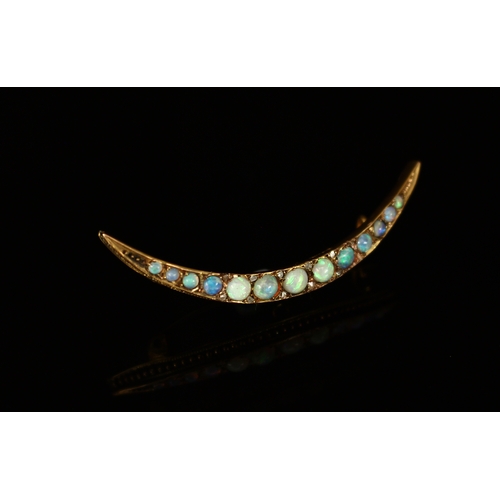 337 - An Edwardian 9ct gold and opal crescent bar brooch, the 13 graduated cabochon stones divided by smal... 