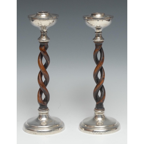 A pair of Arts and Crafts silver and oak open barley twist