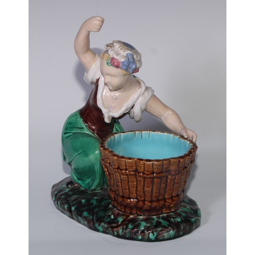 378 - A Minton majolica figure, of a lady kneeling by a basket, her arm raised, in colours, 22cm high, imp... 