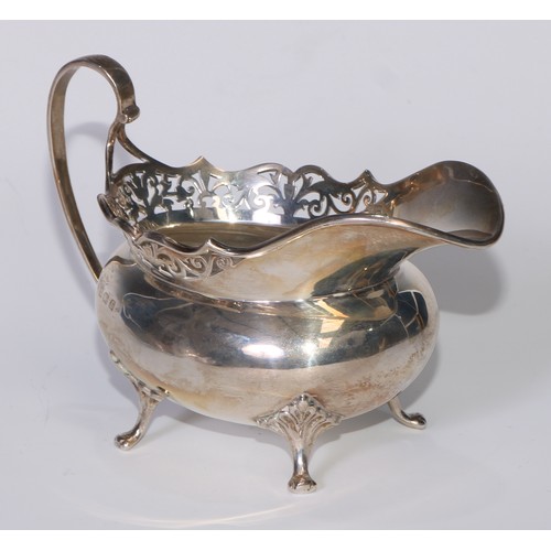 110 - A George V silver tea service, pierced rims, pad feet, Thomas Edward Atkins, Birmingham 1917, 1113g,... 