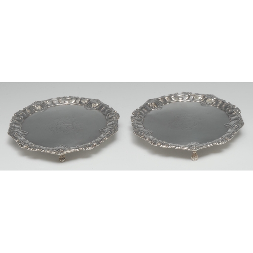 132 - A pair of early George III silver shaped circular waiters, fluted scroll and shell border, ball and ... 