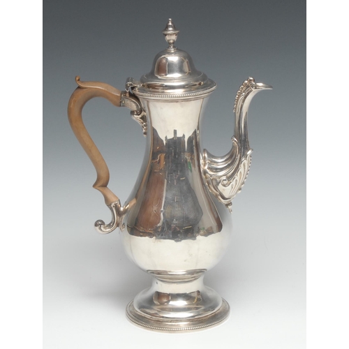 74 - A George III silver baluster coffee pot, hinged domed cover with urnular finial, beaded borders, fru... 