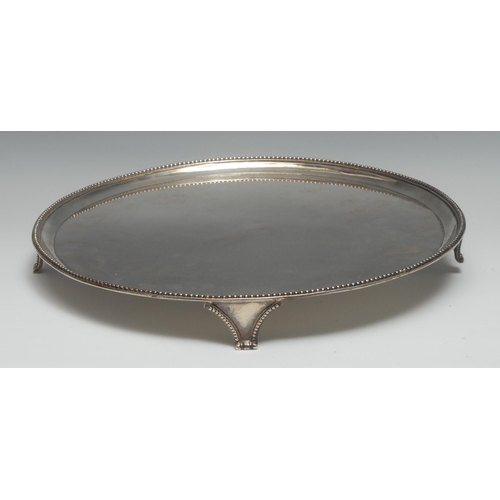 76 - A George III silver circular salver, quite plain, beaded border, tapered feet, 35.5cm diam, John Hut... 