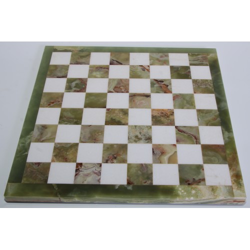 1801 - An onyx and alabaster pietra dura chess board, 32cm wide