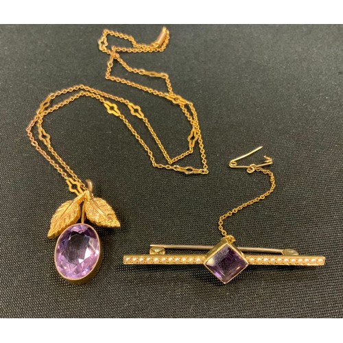 293 - A 9ct gold amethyst pendant necklace, twin leafy mount inset with a single oval amethyst, suspended ... 