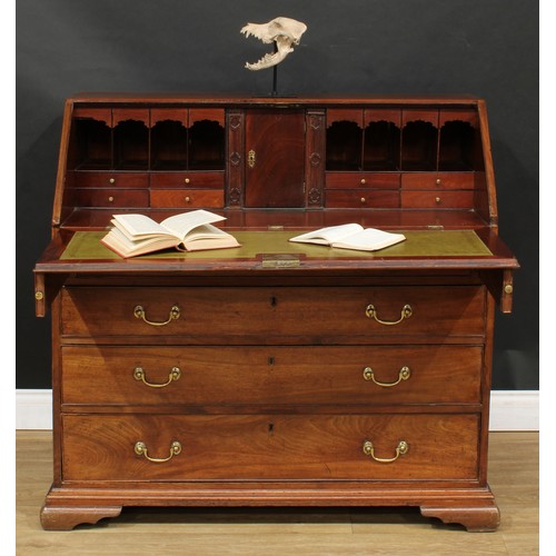 1816 - A George III mahogany bureau, fall front enclosing a writing surface, a door, small drawers, pigeonh... 