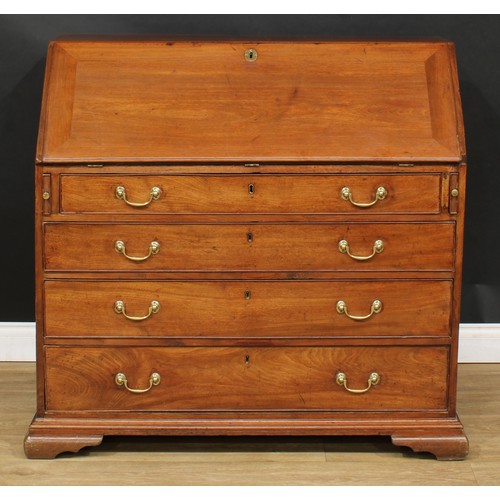 1816 - A George III mahogany bureau, fall front enclosing a writing surface, a door, small drawers, pigeonh... 