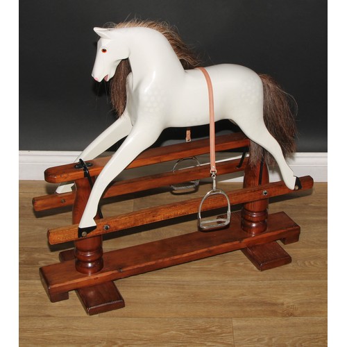 3235 - A 20th century rocking horse of small proportions on safety stand, the carved and later over-painted... 