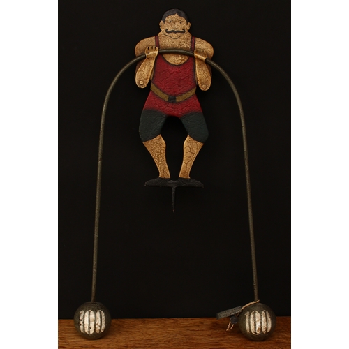 3291 - Folk Art - a novelty balance toy, in the form of a Circus strongman, he stands with his arms towards... 