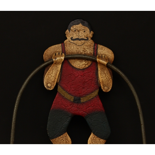 3291 - Folk Art - a novelty balance toy, in the form of a Circus strongman, he stands with his arms towards... 