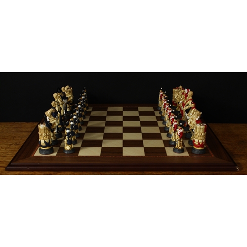 3350 - A Studio Anne Carlton Battle of Waterloo chess set, boxed with literature and a chess board, boxed (... 