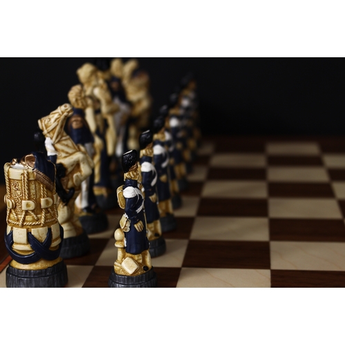 3350 - A Studio Anne Carlton Battle of Waterloo chess set, boxed with literature and a chess board, boxed (... 