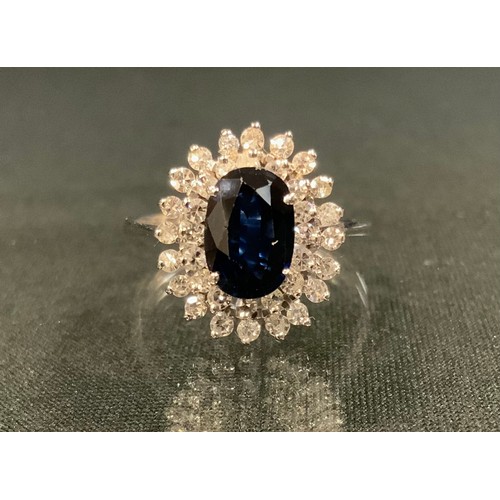 122 - A sapphire and diamond ring, central oval blue sapphire 9mm x 6.7mm x 2.9mm, calculated sapphire wei... 