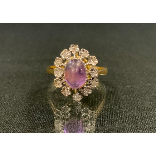 124 - A diamond and pinky purple amethyst ring, oval cabochon amethyst approx 1.60ct, surrounded by an und... 